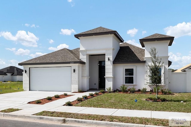 view of front facade with a garage and a front lawn