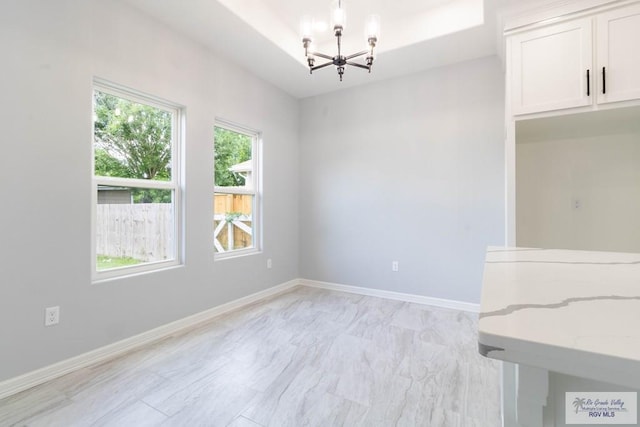 21929 Hand Rd, Harlingen, TX 78552 - unfurnished dining area featuring a chandelier and baseboards