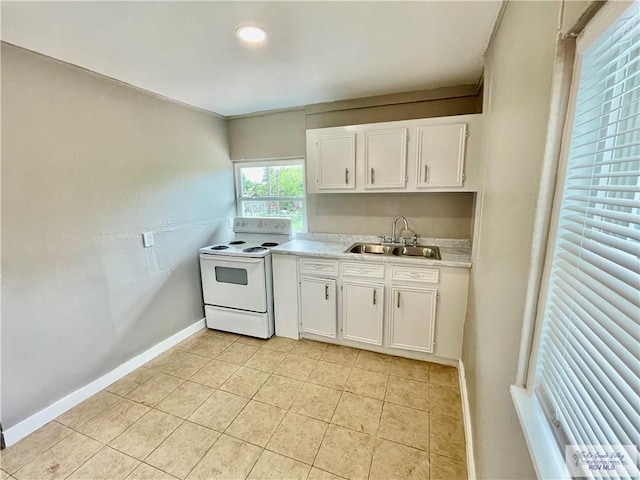 kitchen with white range with electric stovetop, white cabinetry, sink, and light tile patterned floors