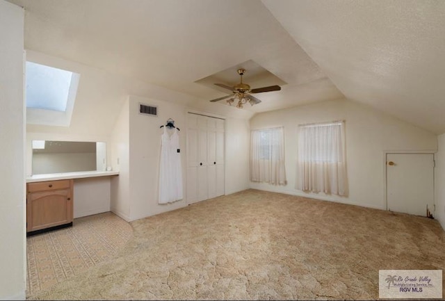 501 Ratliff St, San Benito, TX 78586 - additional living space with a skylight, lofted ceiling, carpet, and a ceiling fan
