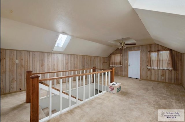 501 Ratliff St, San Benito, TX 78586 - additional living space with wood walls, vaulted ceiling, a skylight, carpet, and ceiling fan