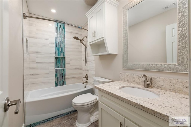 full bathroom with shower / bath combo with shower curtain, toilet, vanity, and hardwood / wood-style flooring