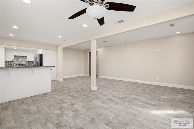 interior space with ceiling fan and light wood-type flooring