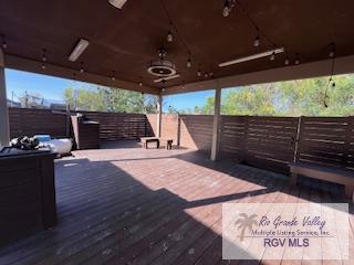 deck with a gazebo and ceiling fan