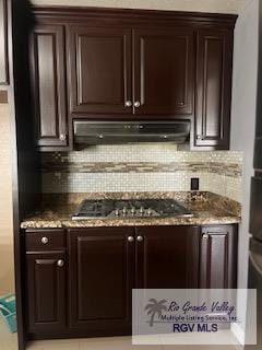 kitchen featuring backsplash, dark brown cabinets, exhaust hood, and stainless steel gas stovetop