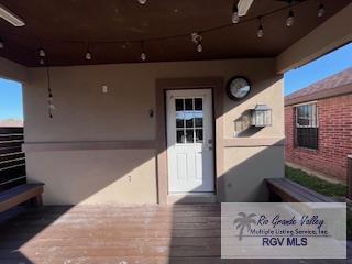 view of exterior entry featuring ceiling fan