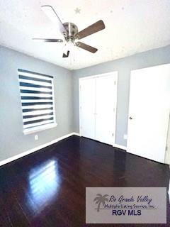 spare room featuring hardwood / wood-style floors and ceiling fan