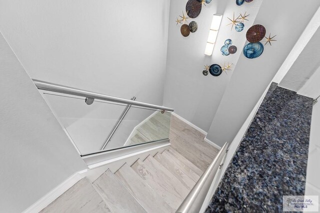 stairs featuring hardwood / wood-style floors