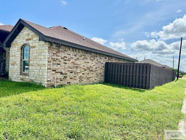 401 S Tamm Ln, Harlingen, TX 78550 - view of side of home with roof with shingles and brick siding
