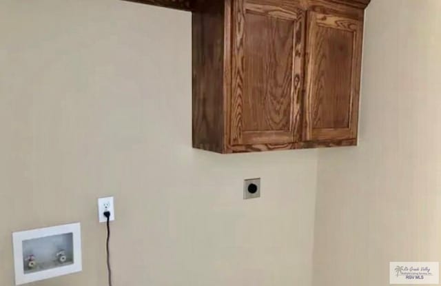 401 S Tamm Ln, Harlingen, TX 78550 - laundry area with cabinet space, washer hookup, and hookup for an electric dryer