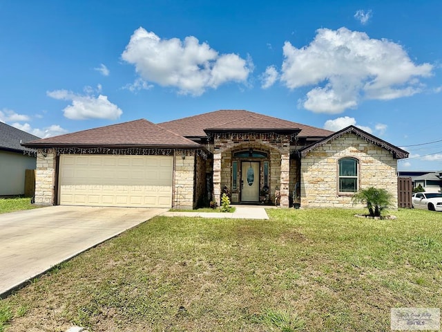 401 S Tamm Ln, Harlingen, TX 78550 - french country inspired facade with driveway, an attached garage, a front yard, stone siding, and a shingled roof