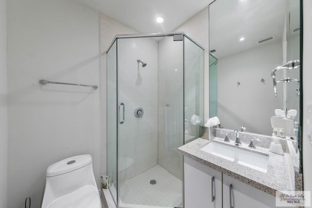 bathroom with walk in shower, vanity, and toilet