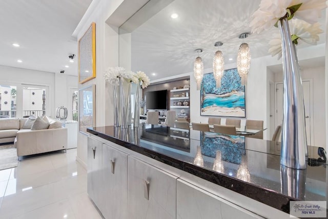 kitchen with pendant lighting and light tile patterned flooring