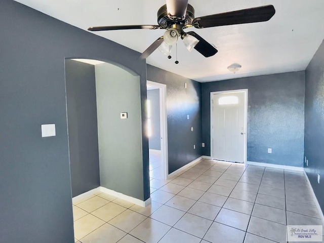 spare room with light tile patterned floors and ceiling fan