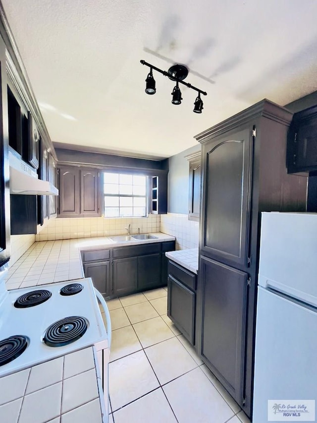 kitchen with backsplash, white appliances, ventilation hood, dark brown cabinetry, and light tile patterned floors