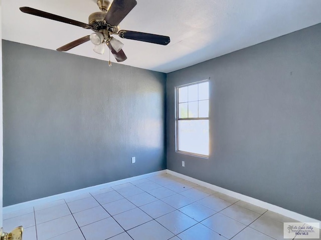 spare room featuring ceiling fan and light tile patterned floors