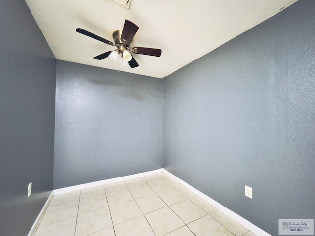 tiled empty room featuring ceiling fan