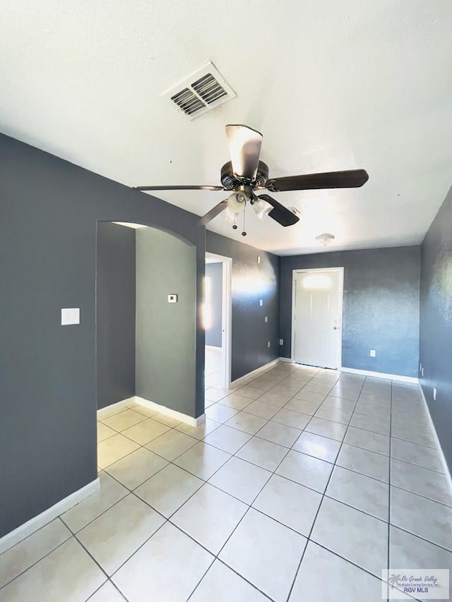 spare room featuring ceiling fan and light tile patterned flooring