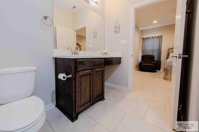 half bath with tile patterned flooring, baseboards, vanity, and toilet