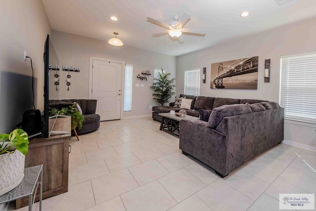 living room featuring light tile patterned floors, ceiling fan, baseboards, and recessed lighting