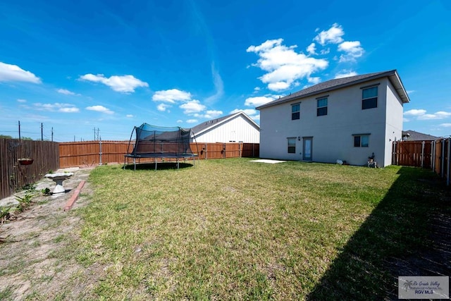 view of yard with a fenced backyard and a trampoline