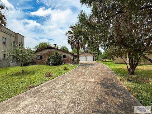 38 Palmetto Cir, Brownsville, TX 78521 - view of front of home featuring an outbuilding, brick siding, a garage, and concrete driveway