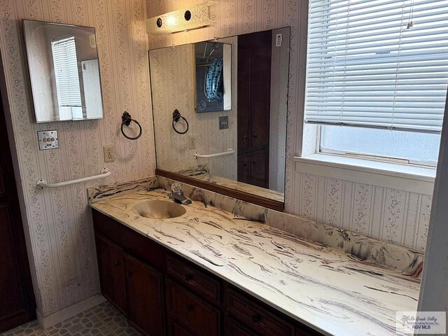 38 Palmetto Cir, Brownsville, TX 78521 - bathroom with vanity, wallpapered walls, and baseboards