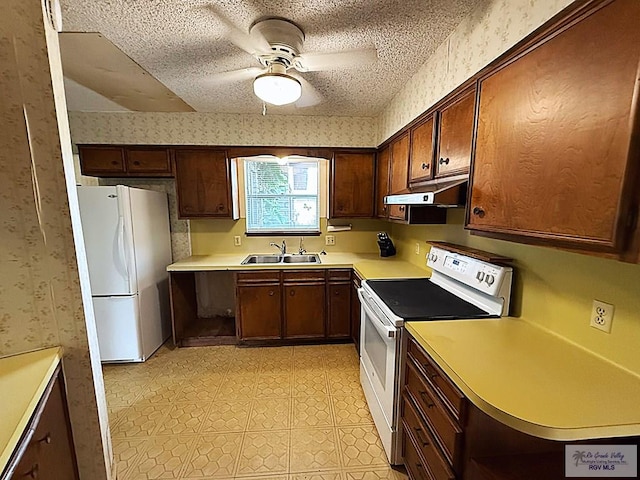 38 Palmetto Cir, Brownsville, TX 78521 - kitchen featuring white appliances, wallpapered walls, under cabinet range hood, a sink, and a ceiling fan