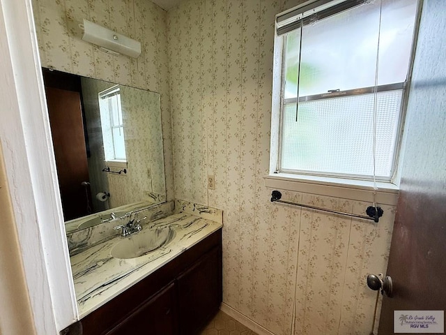 38 Palmetto Cir, Brownsville, TX 78521 - bathroom featuring vanity, wallpapered walls, baseboards, and tile patterned flooring