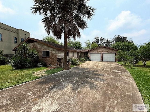38 Palmetto Cir, Brownsville, TX 78521 - single story home with concrete driveway, an attached garage, brick siding, and a front lawn