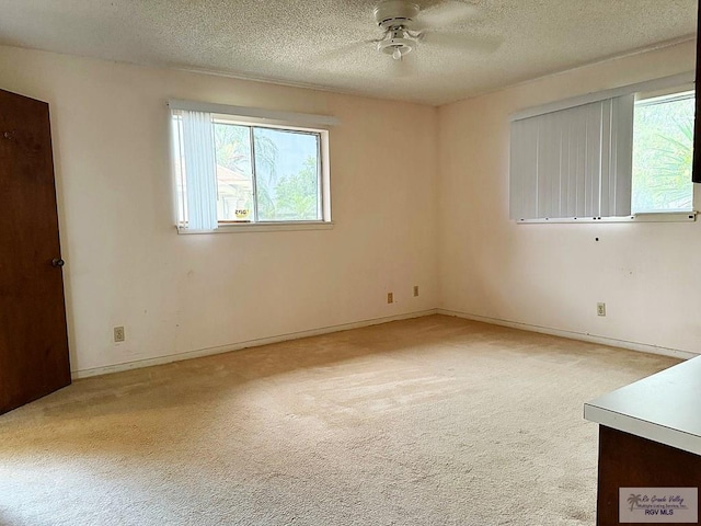 38 Palmetto Cir, Brownsville, TX 78521 - unfurnished room featuring healthy amount of natural light, light colored carpet, a ceiling fan, a textured ceiling, and baseboards