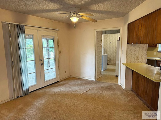 38 Palmetto Cir, Brownsville, TX 78521 - unfurnished dining area with french doors, light colored carpet, ceiling fan, a textured ceiling, and washer / dryer