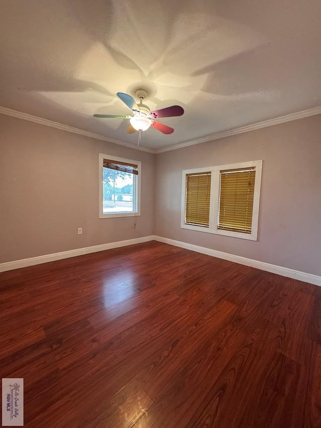 empty room with ceiling fan, dark hardwood / wood-style flooring, and ornamental molding