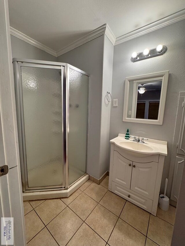 bathroom with vanity, tile patterned floors, walk in shower, and ornamental molding