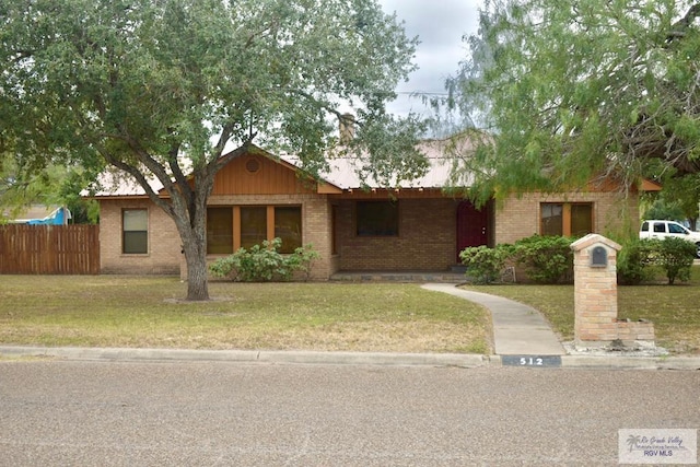 ranch-style house featuring a front lawn