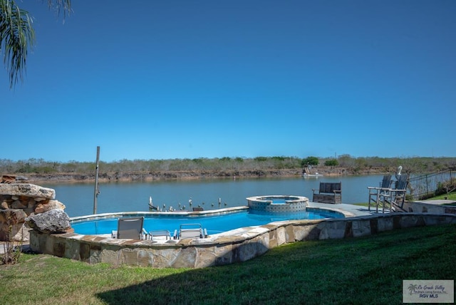 view of swimming pool with a water view, a pool with connected hot tub, and a yard