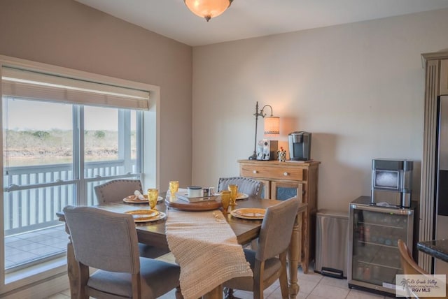 dining space with beverage cooler and light tile patterned flooring