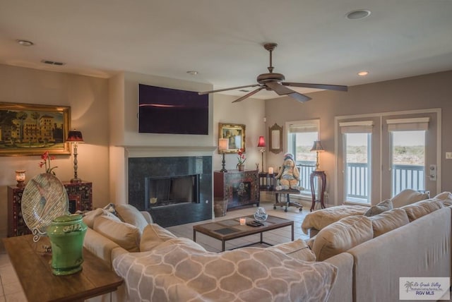 living area featuring a high end fireplace, visible vents, ceiling fan, and recessed lighting