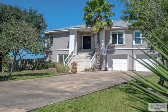 view of front of house with stairs, decorative driveway, a garage, and stucco siding