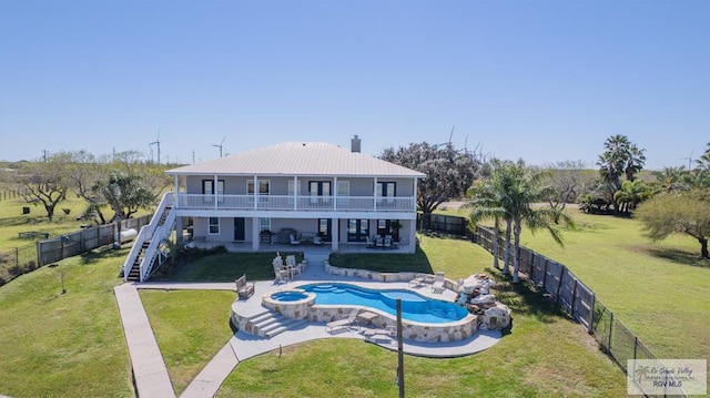 rear view of house with a fenced backyard, stairway, and a yard