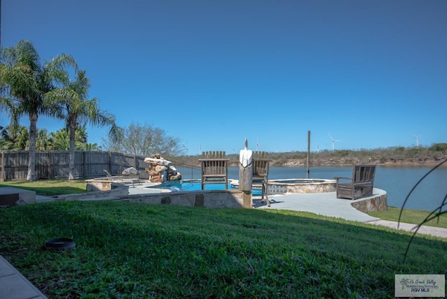 view of yard with an outdoor fire pit, a patio area, a water view, and fence