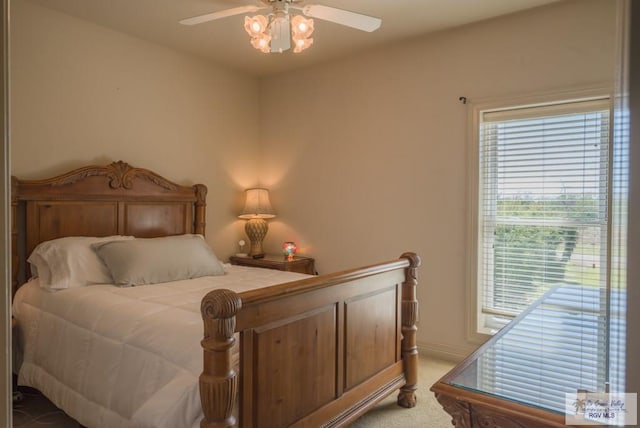 bedroom featuring baseboards, a ceiling fan, and light colored carpet