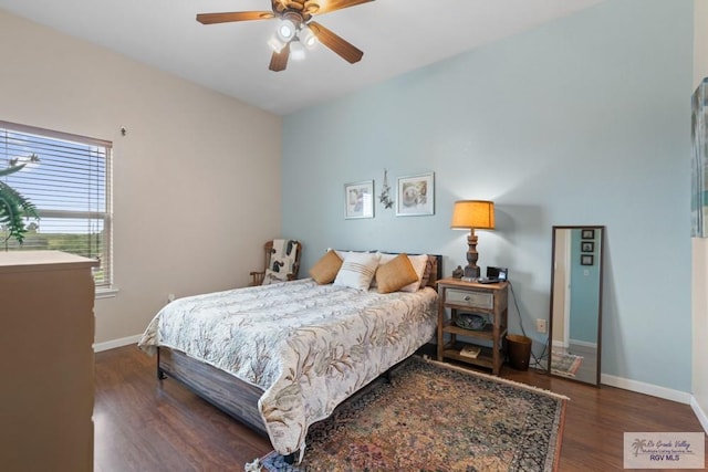 bedroom with a ceiling fan, baseboards, and wood finished floors