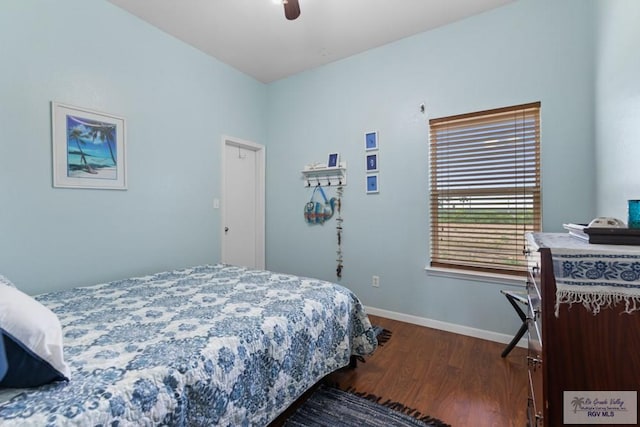 bedroom featuring baseboards, ceiling fan, and wood finished floors