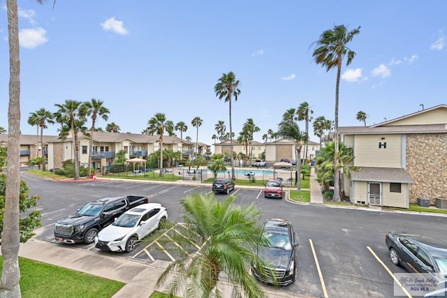view of street with a residential view, sidewalks, and curbs
