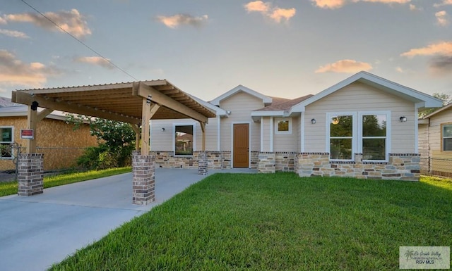 view of front of property with a lawn and a carport