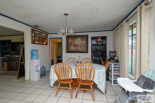 307 W Boone Ave, Pharr, TX 78577 - dining space with light tile patterned floors, a chandelier, and crown molding
