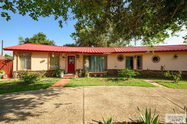 307 W Boone Ave, Pharr, TX 78577 - ranch-style home with stucco siding, a metal roof, and a front yard