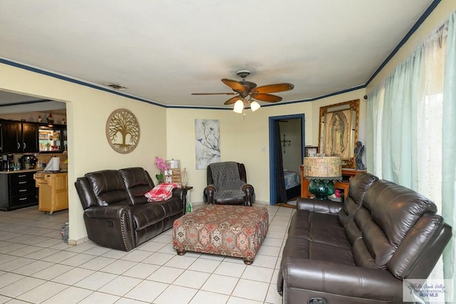307 W Boone Ave, Pharr, TX 78577 - living room featuring light tile patterned flooring, a ceiling fan, and crown molding