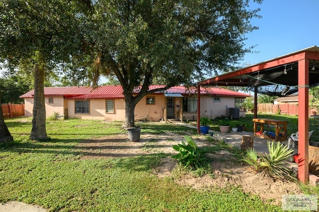 307 W Boone Ave, Pharr, TX 78577 - rear view of property featuring stucco siding and a metal roof